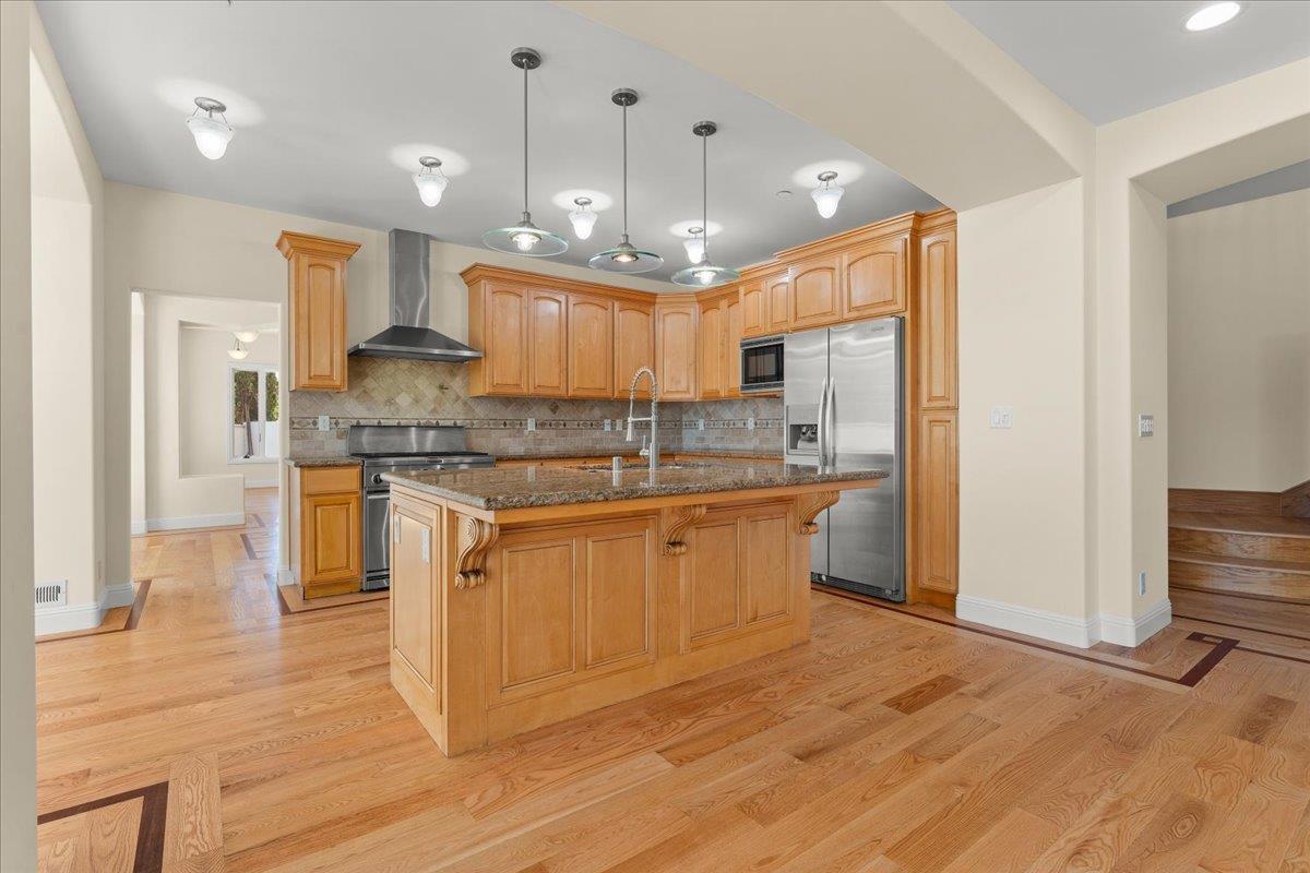 2100 Stone Ridge Drive Watsonville, CA 95076 - Photo 13 of 50 a large kitchen with granite countertop a large counter top a sink stainless steel appliances and cabinets