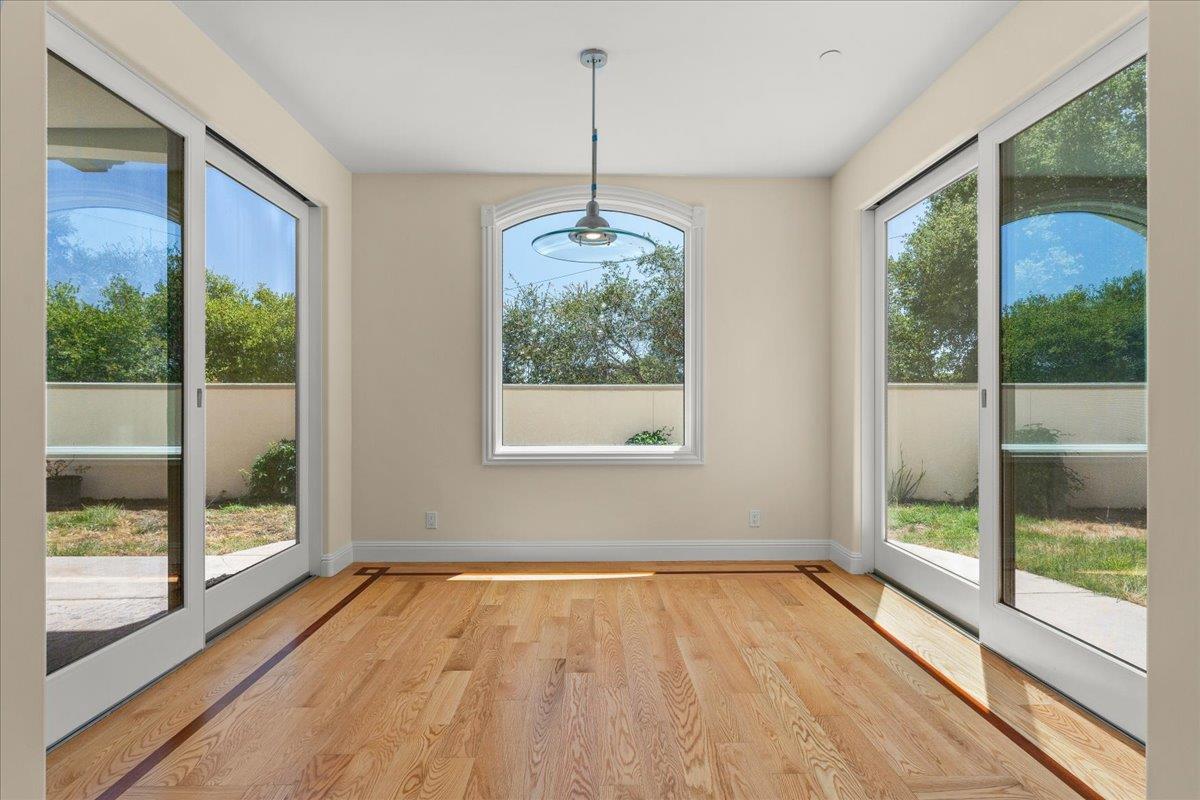 2100 Stone Ridge Drive Watsonville, CA 95076 - Photo 16 of 50 a view of empty room with wooden floor and floor to ceiling window