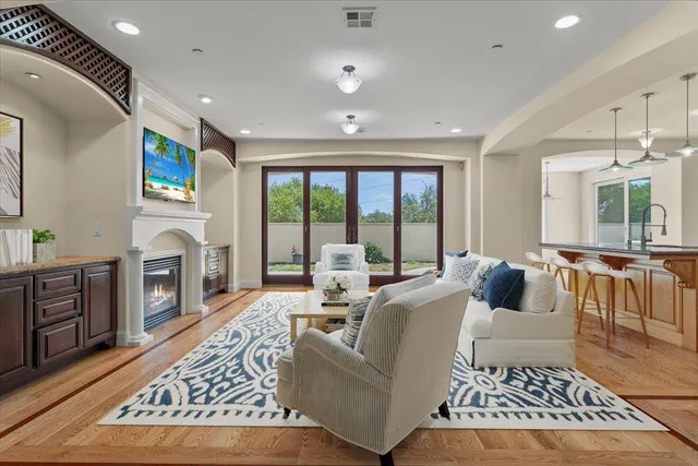 a living room with furniture a fireplace and a flat screen tv