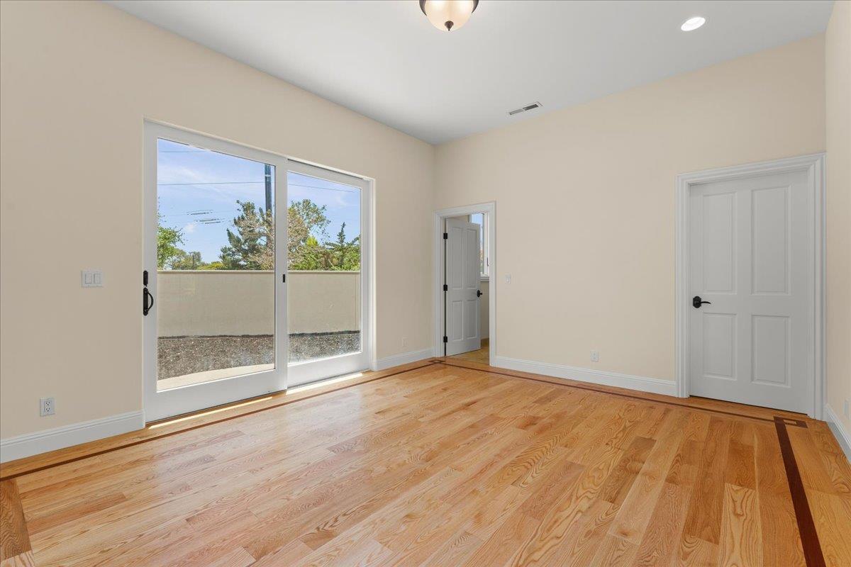 2100 Stone Ridge Drive Watsonville, CA 95076 - Photo 19 of 50 a view of an empty room with wooden floor and a window