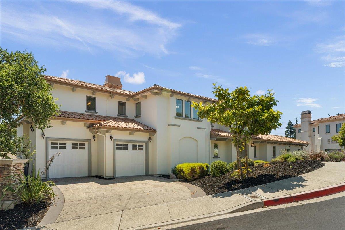 2100 Stone Ridge Drive Watsonville, CA 95076 - Photo 2 of 50 a front view of a house with a garage and balcony