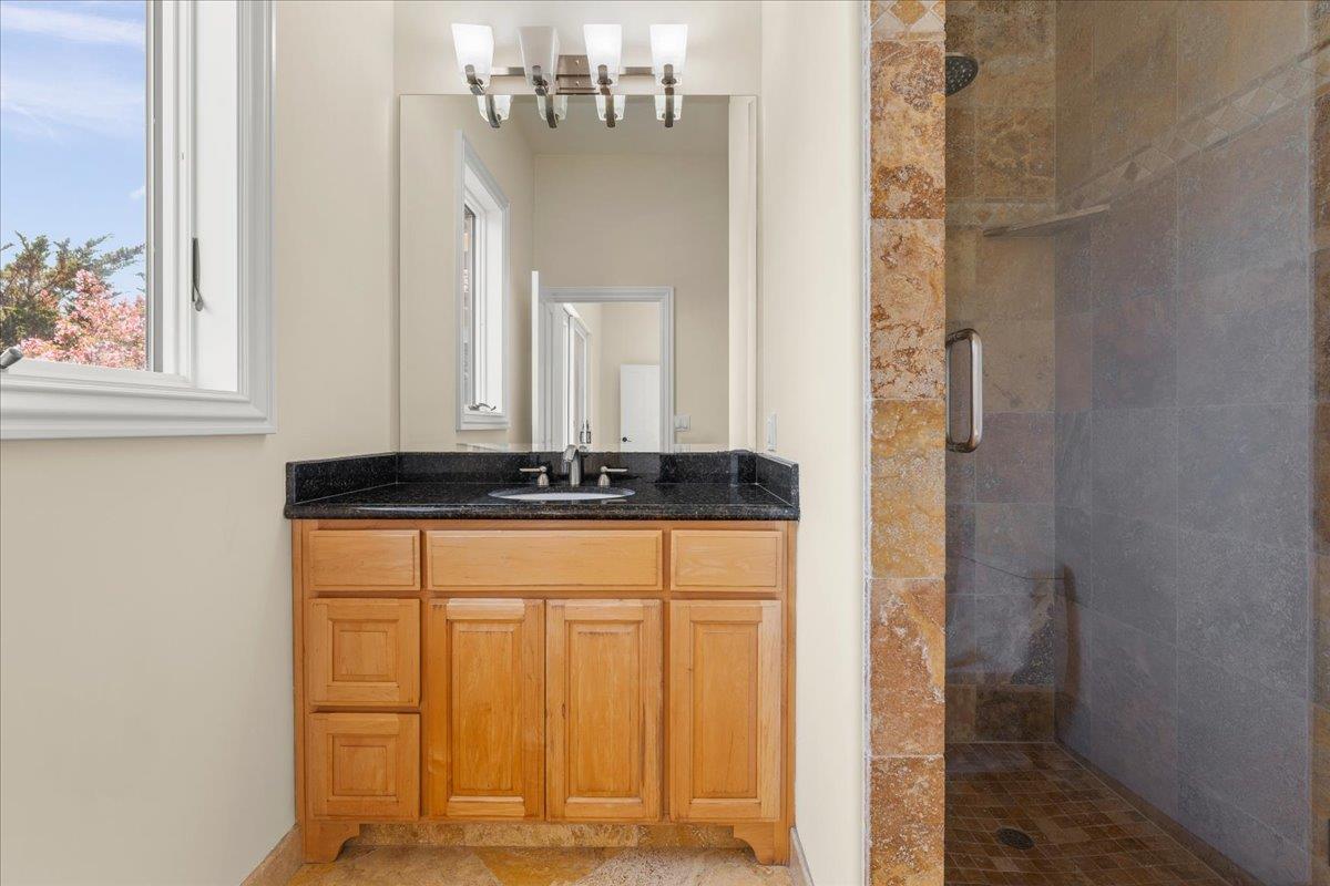 2100 Stone Ridge Drive Watsonville, CA 95076 - Photo 21 of 50 a bathroom with a granite countertop sink and a mirror