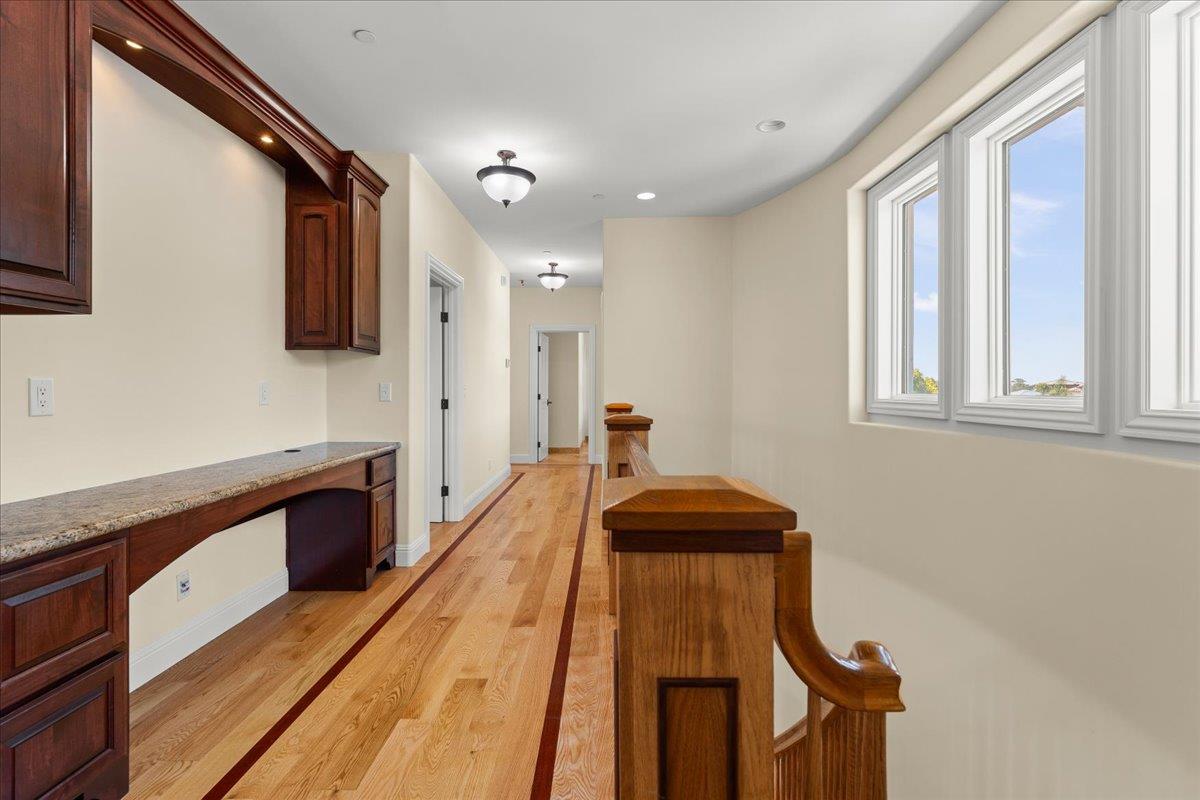 2100 Stone Ridge Drive Watsonville, CA 95076 - Photo 22 of 50 a hallway with a sink and wooden floor