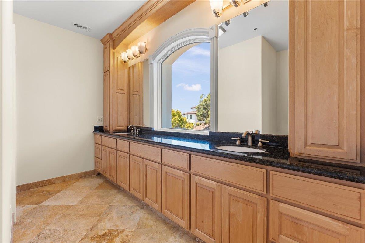 2100 Stone Ridge Drive Watsonville, CA 95076 - Photo 24 of 50 a bathroom with a double vanity sink and a mirror
