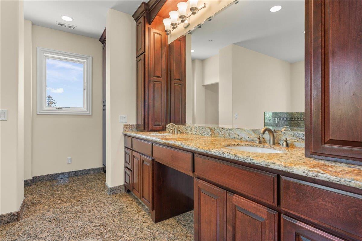 2100 Stone Ridge Drive Watsonville, CA 95076 - Photo 29 of 50 a bathroom with a granite countertop sink and a mirror