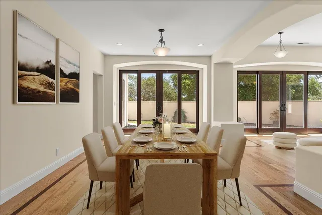 a view of a dining room with furniture large windows and wooden floor