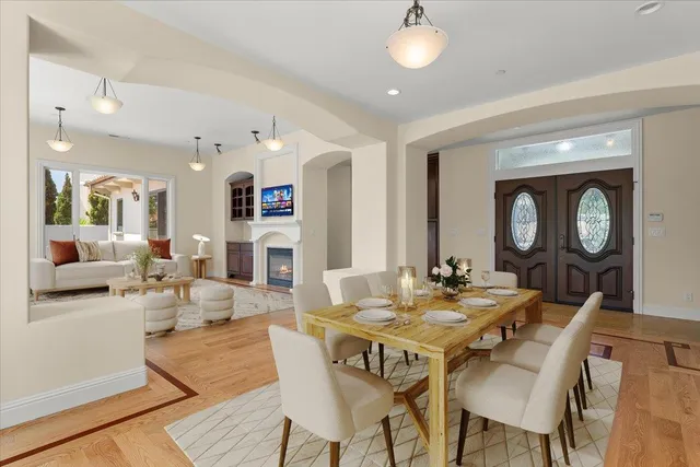 a view of a dining room with furniture and a chandelier