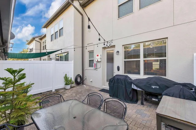 a dining room with furniture and a potted plant