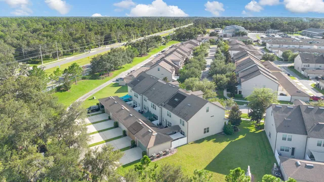 an aerial view of a house with a garden and lake view