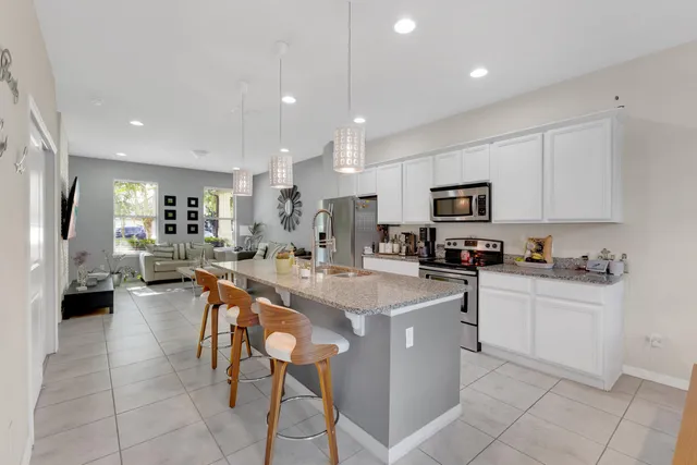 a kitchen with cabinets a sink and appliances