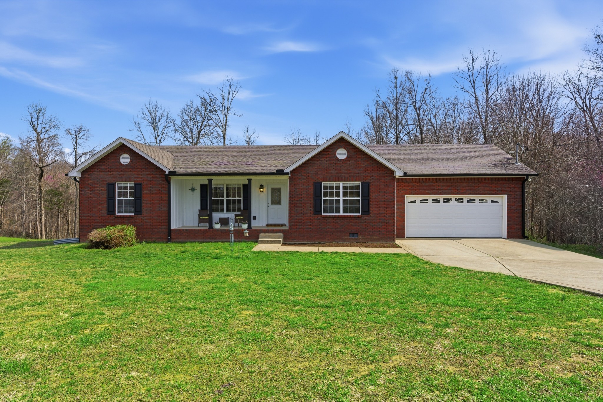 a view of a house with a yard and tree s
