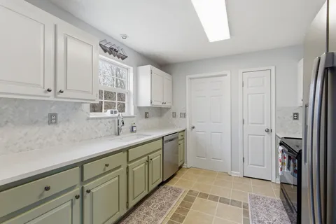 a kitchen with a sink and cabinets