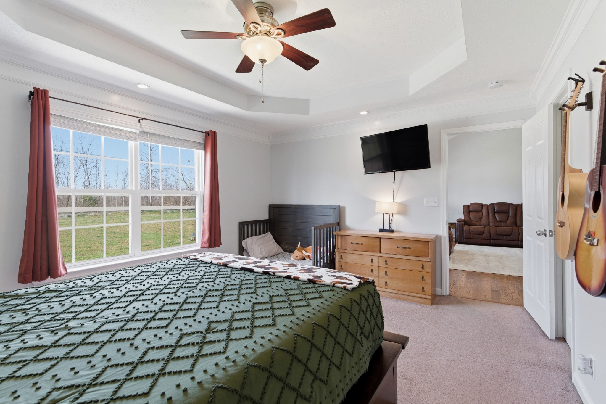 3080 Bowker Road Charlotte, TN 37036 - Photo 18 of 31 a bedroom with a bed and a flat screen tv