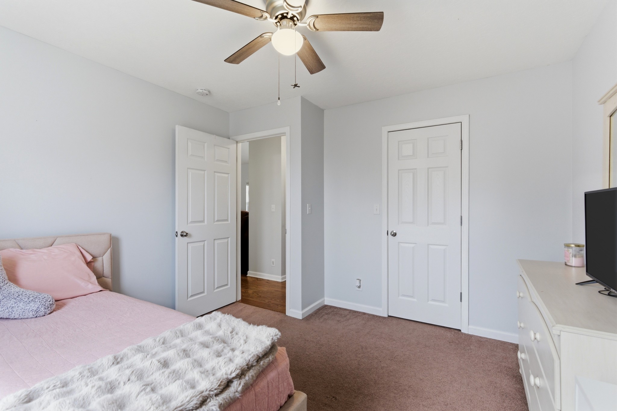 3080 Bowker Road Charlotte, TN 37036 - Photo 20 of 31 a bedroom with a bed and a flat tv screen on dresser