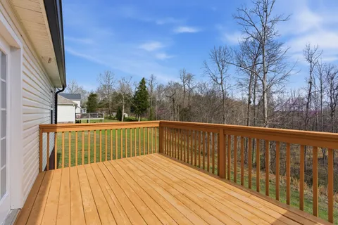 a view of balcony with wooden floor and fence
