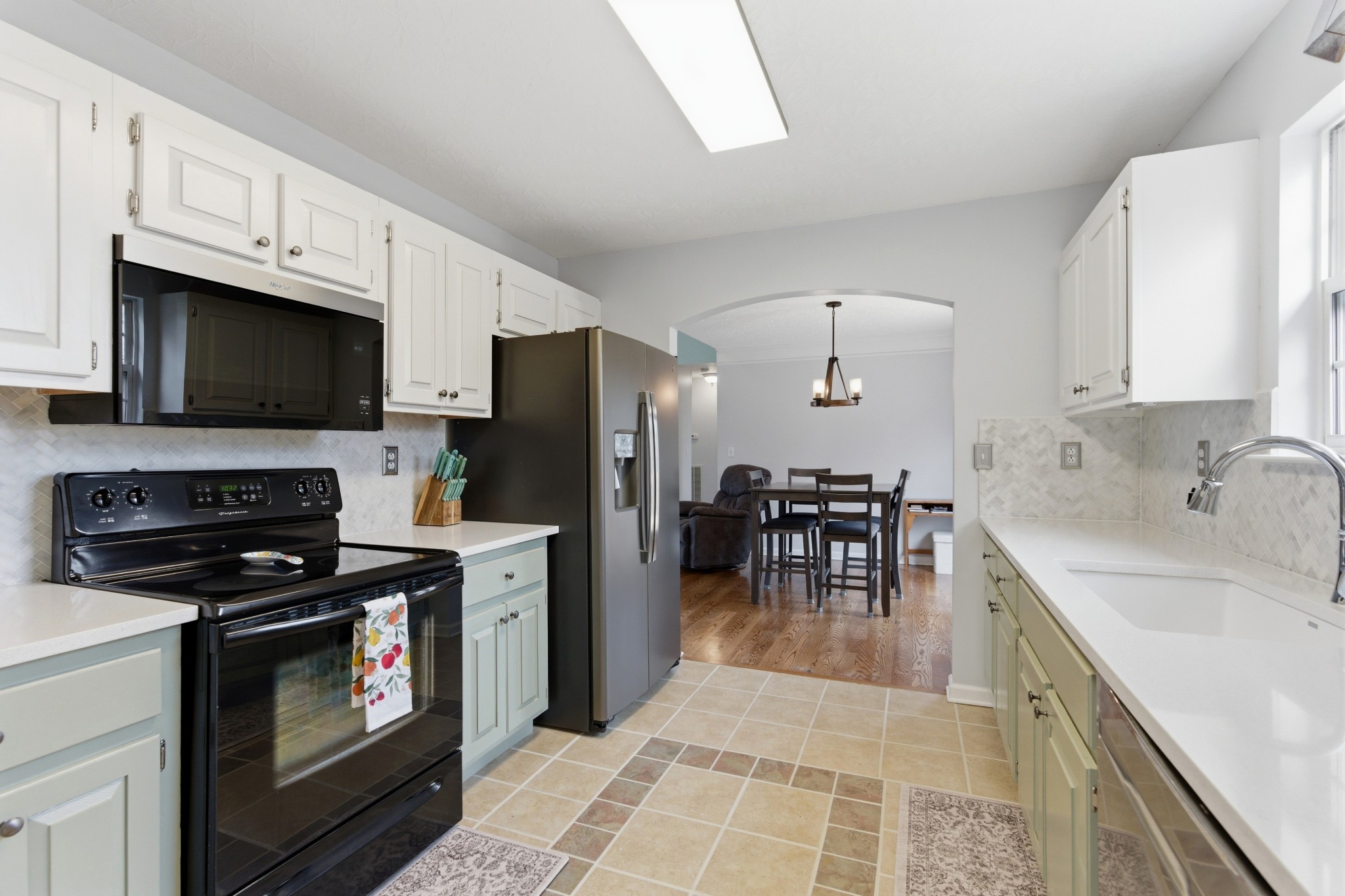 3080 Bowker Road Charlotte, TN 37036 - Photo 5 of 31 a kitchen with granite countertop a stove a sink a microwave and refrigerator