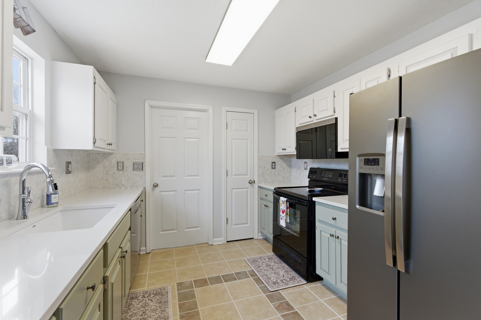 3080 Bowker Road Charlotte, TN 37036 - Photo 10 of 31 a kitchen with stainless steel appliances granite countertop a sink stove and refrigerator