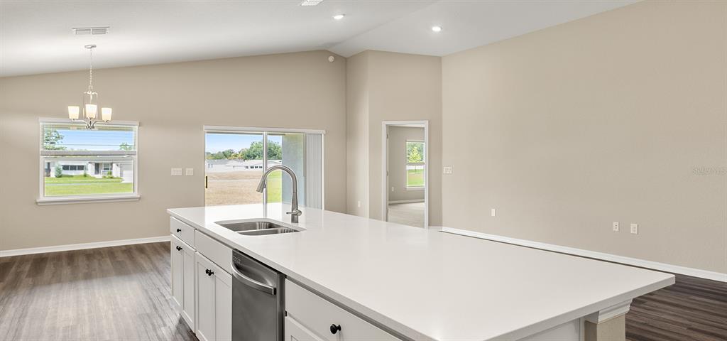 7654 Southwest 6th Loop Ocala, FL 34474 - Photo 15 of 28 a room with a table chairs and wooden floor