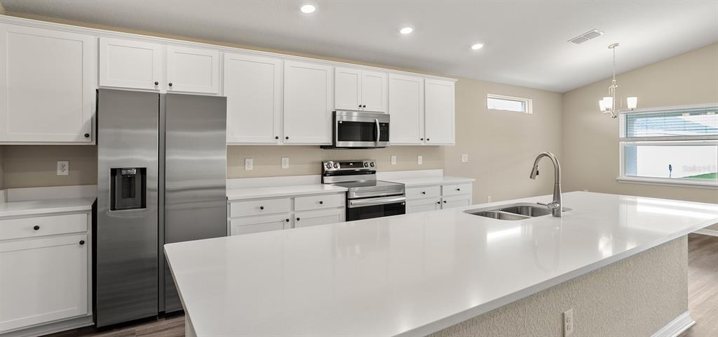 7654 Southwest 6th Loop Ocala, FL 34474 - Photo 18 of 28 a kitchen with stainless steel appliances a refrigerator sink and microwave