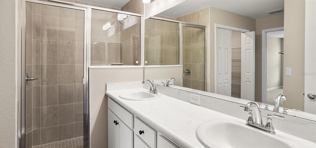 7654 Southwest 6th Loop Ocala, FL 34474 - Photo 20 of 28 a bathroom with a double vanity sink and a mirror