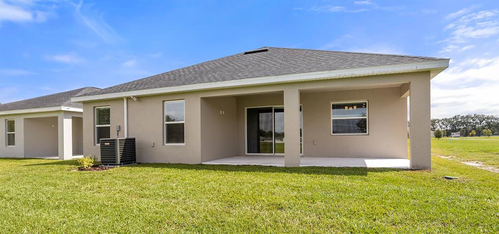 7654 Southwest 6th Loop Ocala, FL 34474 - Photo 28 of 28 front view of the house with a yard