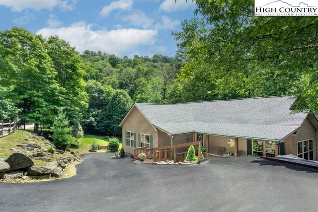 a view of a deck with chairs next to a yard