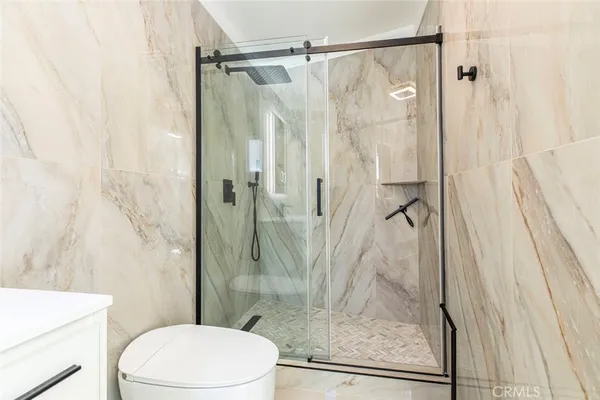 a bathroom with a shower and toilet