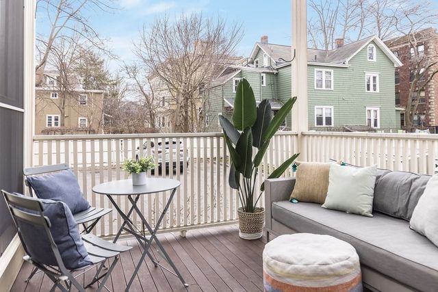 a view of a chair and tables in the back yard of the house
