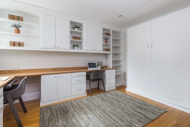 a kitchen with a cabinets and a wooden floor