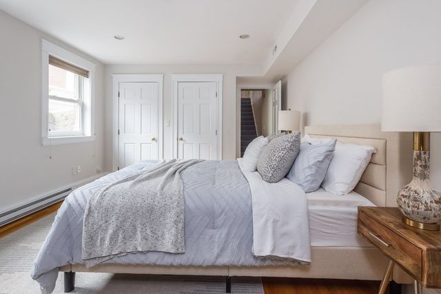 a bedroom with double bed and a window