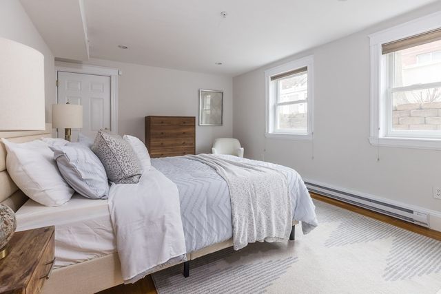 a bathroom with a granite countertop sink toilet a mirror and shower