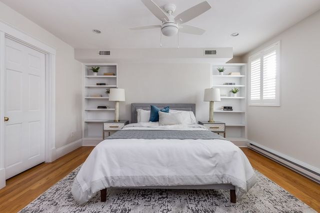 a bedroom with a large bed and a chandelier