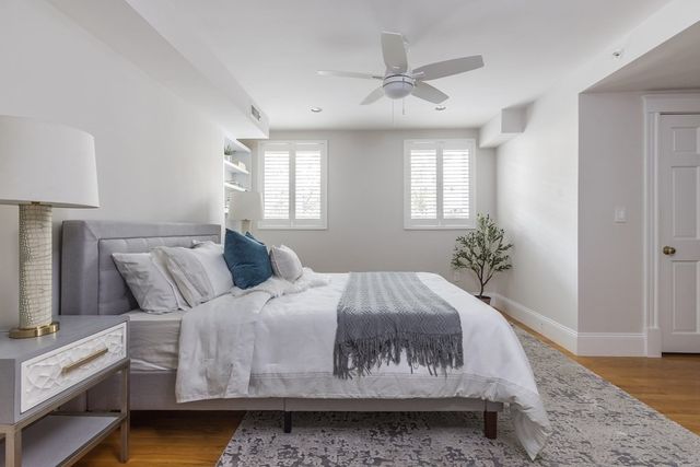 a bedroom with a bed dresser and a window