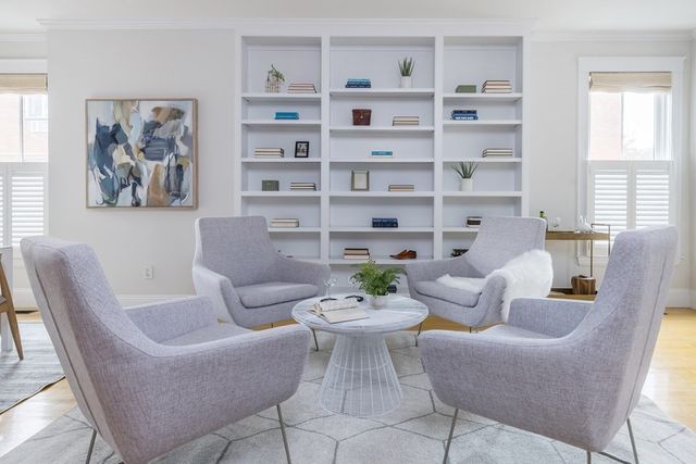 a living room with furniture and a book shelf