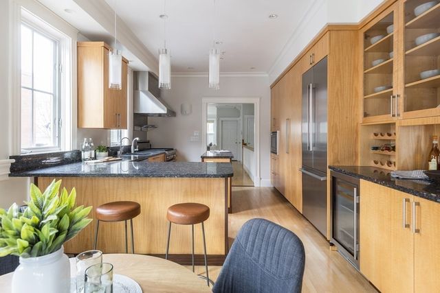 a kitchen with stainless steel appliances granite countertop a sink and a refrigerator