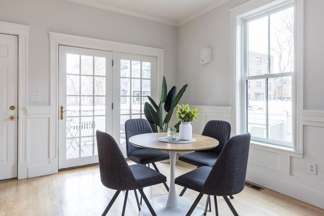 a view of a dining room with furniture window and wooden floor