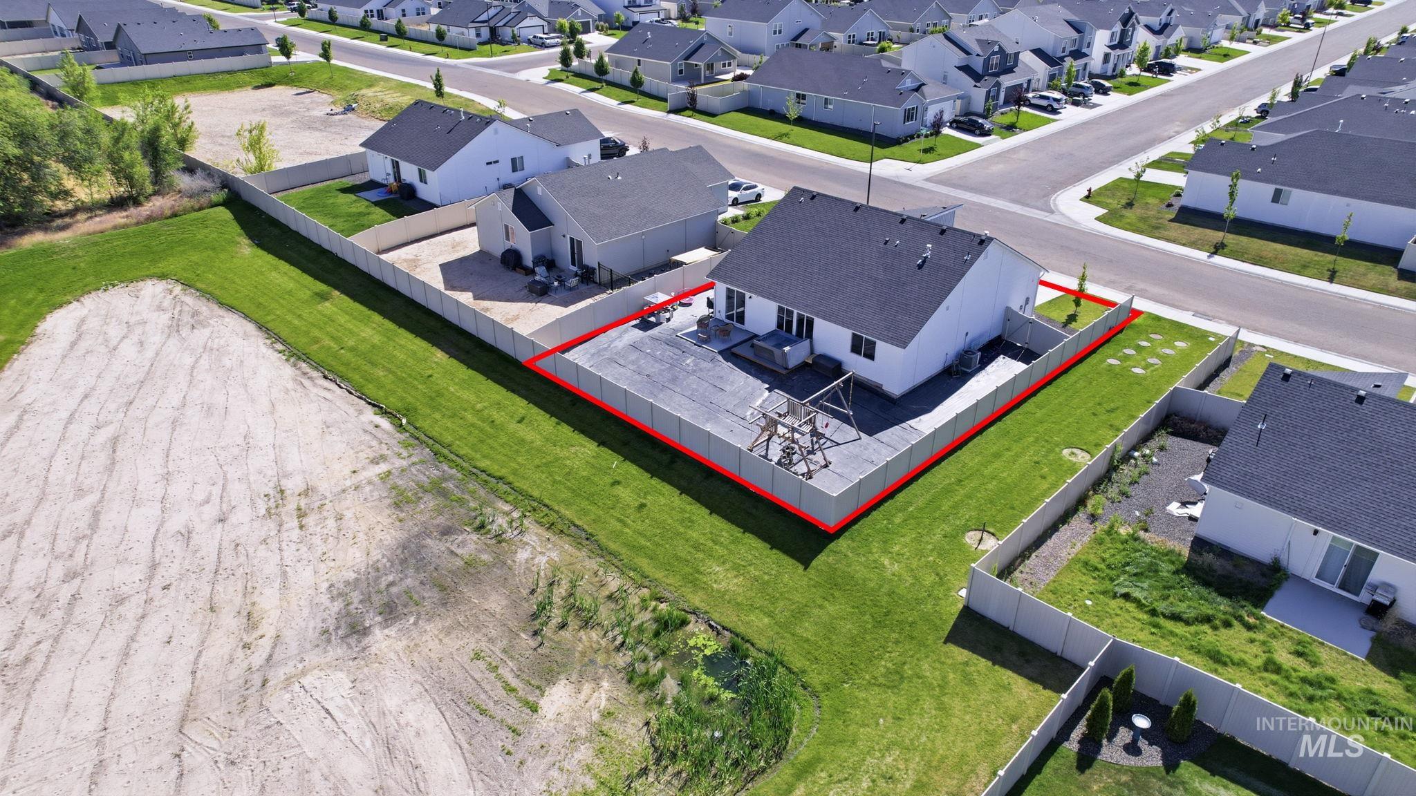 16780 Breton Way Caldwell, ID 83607 - Photo 25 of 28 Rear exterior featuring white siding and a dark shingle roof