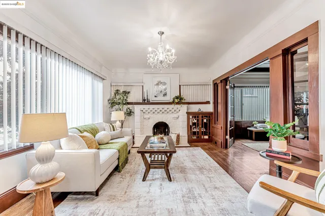 a living room with furniture a fireplace and a large window