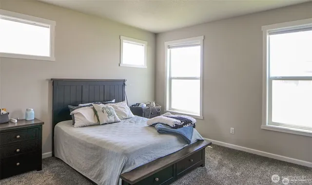 a bedroom with a bed and window
