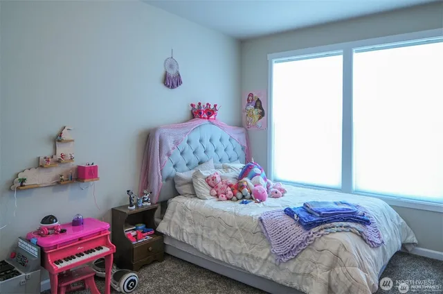 a bedroom with a bed dresser and a window