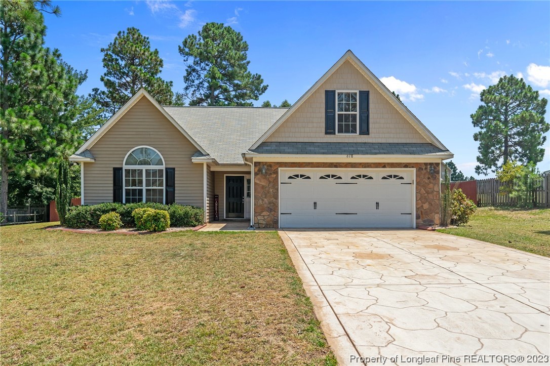 618 Valley Oak Drive Bunnlevel, NC 28323 - Photo 1 of 38 a front view of a house with a yard and garage