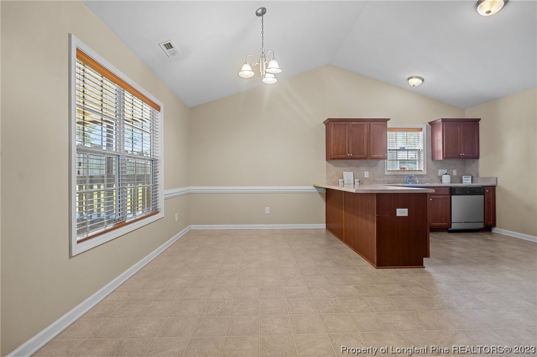 618 Valley Oak Drive Bunnlevel, NC 28323 - Photo 12 of 38 a view of kitchen with stainless steel appliances granite countertop a stove and a sink