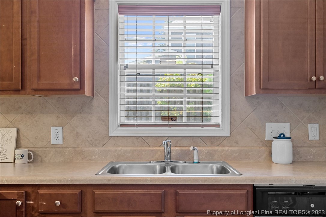 618 Valley Oak Drive Bunnlevel, NC 28323 - Photo 14 of 38 a kitchen with granite countertop a sink and a window