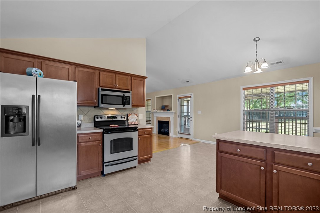618 Valley Oak Drive Bunnlevel, NC 28323 - Photo 15 of 38 a kitchen with stainless steel appliances granite countertop a refrigerator a stove a sink and a microwave