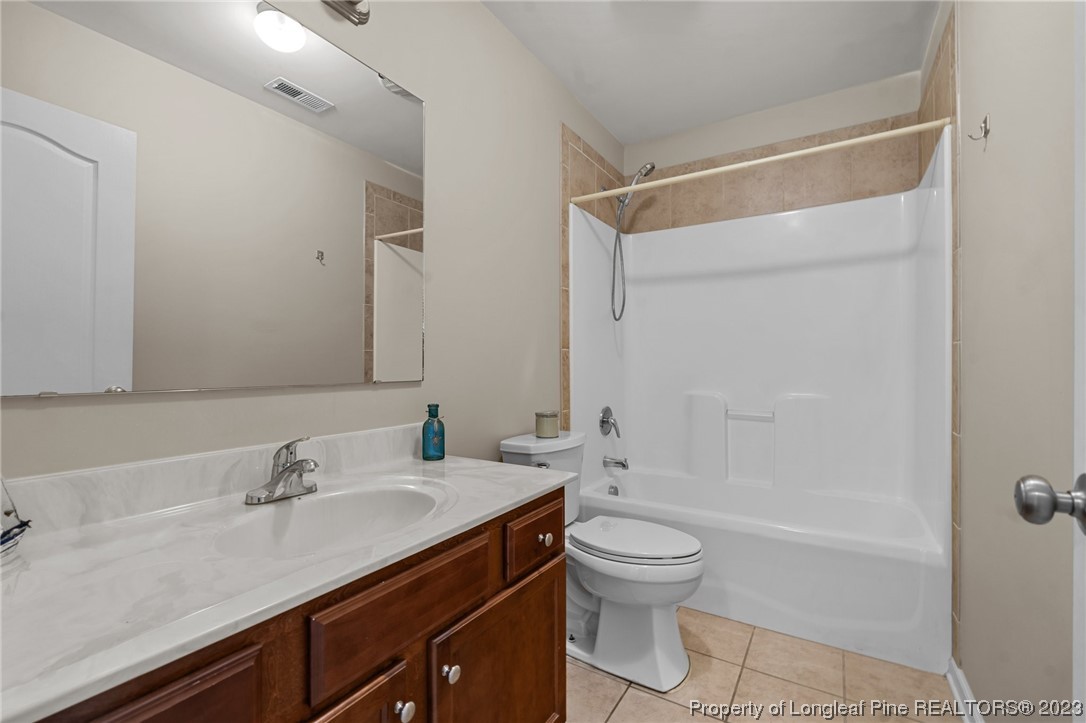 618 Valley Oak Drive Bunnlevel, NC 28323 - Photo 19 of 38 a bathroom with a shower sink vanity mirror and toilet