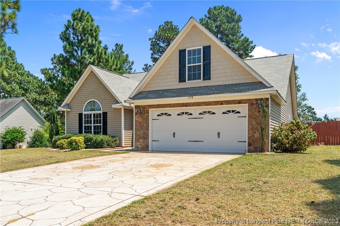 618 Valley Oak Drive Bunnlevel, NC 28323 - Photo 2 of 38 a front view of a house with a yard and garage