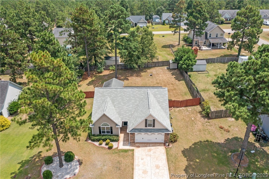 618 Valley Oak Drive Bunnlevel, NC 28323 - Photo 36 of 38 an aerial view of a house with swimming pool and large trees