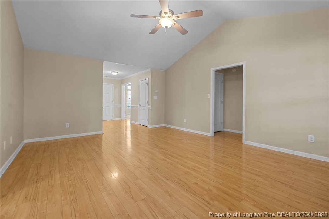 618 Valley Oak Drive Bunnlevel, NC 28323 - Photo 7 of 38 a view of an empty room with wooden floor and a ceiling fan