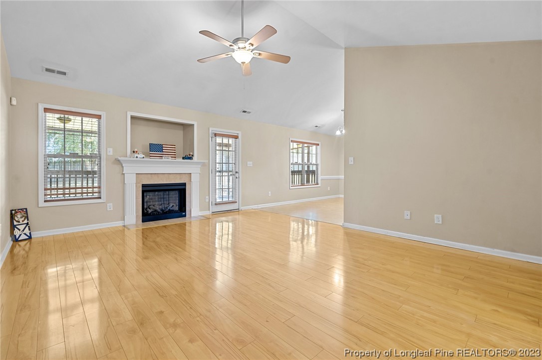 618 Valley Oak Drive Bunnlevel, NC 28323 - Photo 8 of 38 wooden floor fireplace and windows in an empty room
