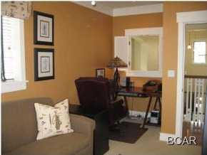 1105 Prospect Promenade, Unit 101 Panama City Beach, FL 32413 - Photo 11 of 27 a view of a workspace with furniture and a mirror